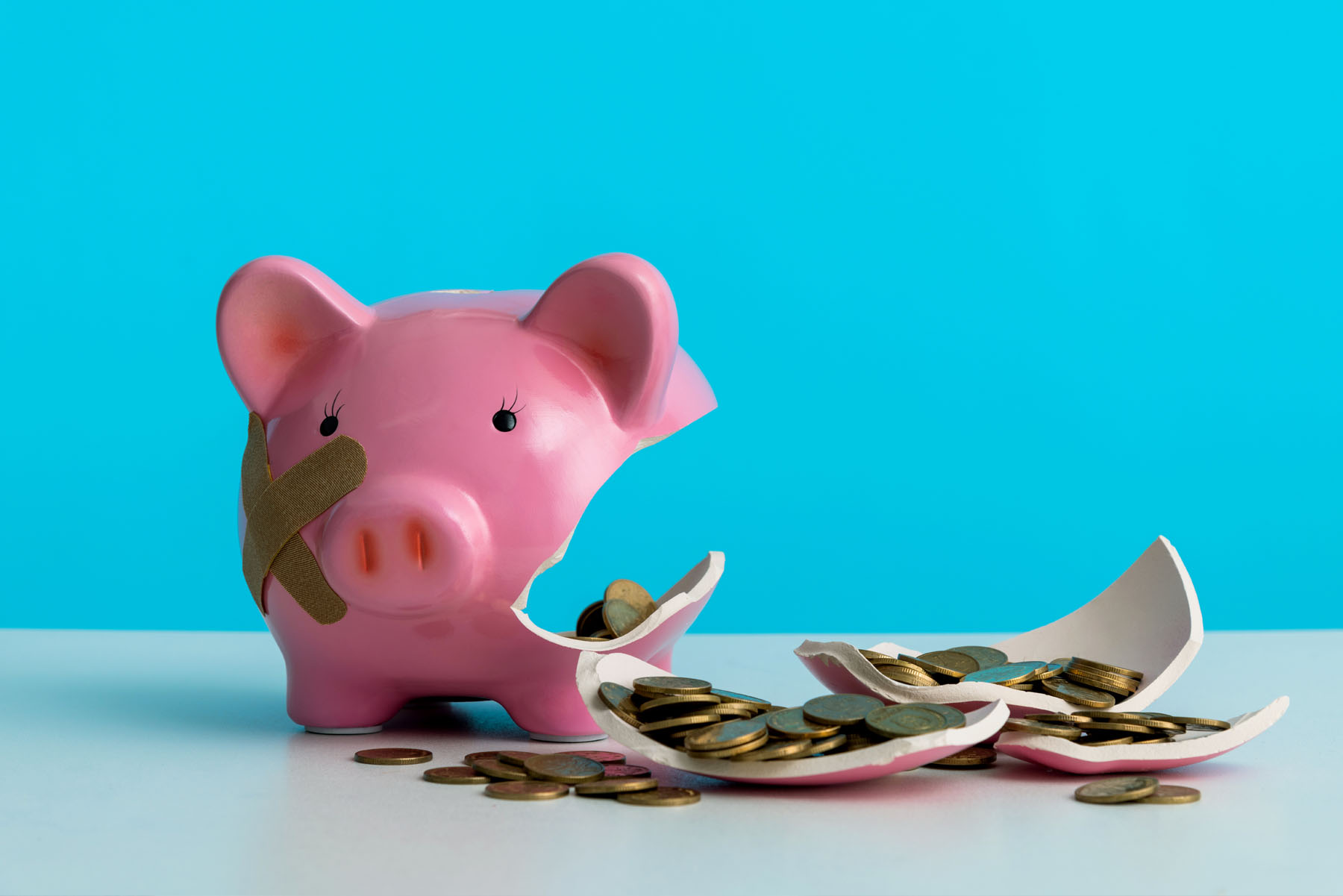 A piggy bank broke open to get at emergency funds