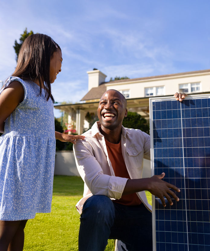 Man showing his daughter the solar panels he bought with his HELOC from ServU