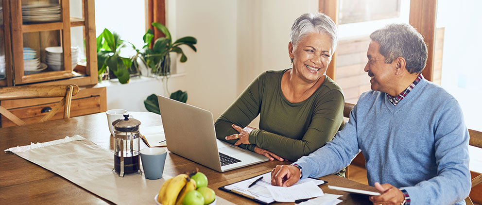 An older couple reviews insurance paperwork