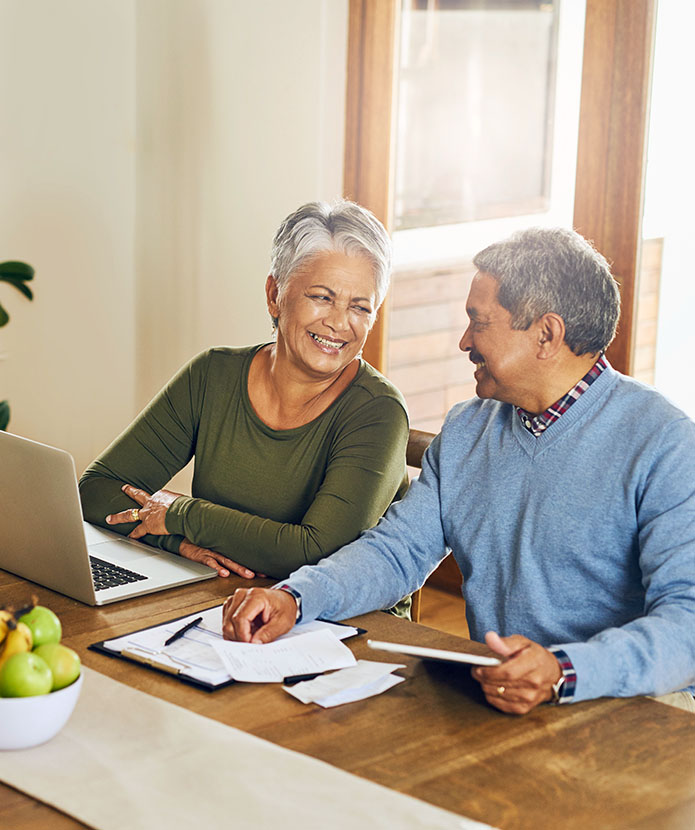 An older couple reviews insurance paperwork