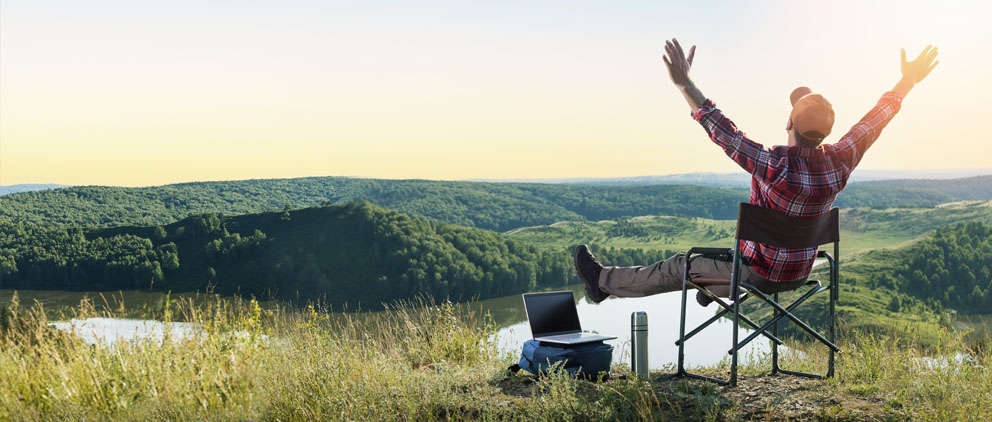 Man on top of a mountain proving that he can bank from anywhere