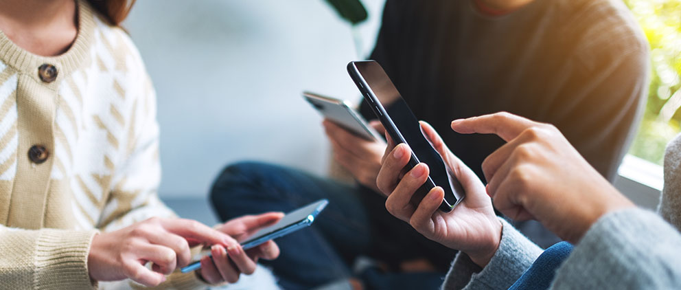 A group of friends using their phones