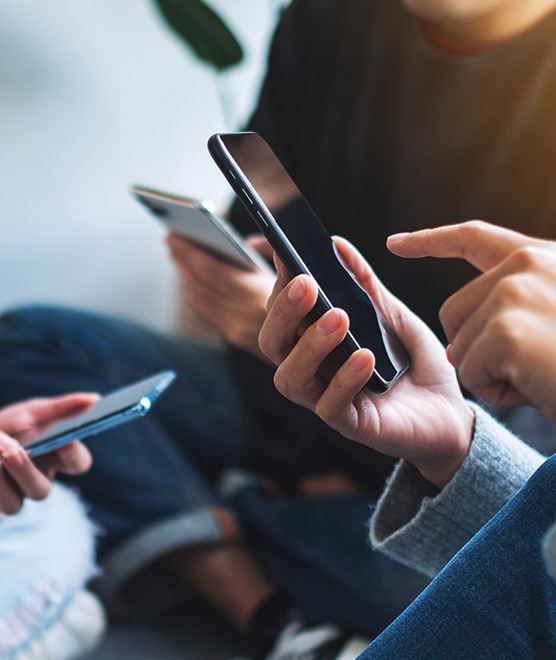 A group of friends using their phones