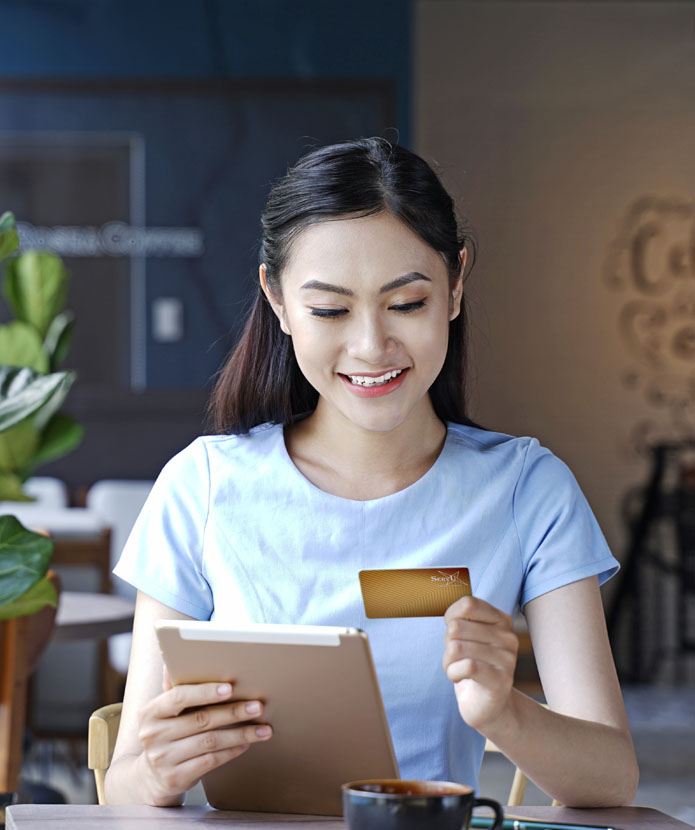 Woman shopping on with her ServU Visa Rewards Card