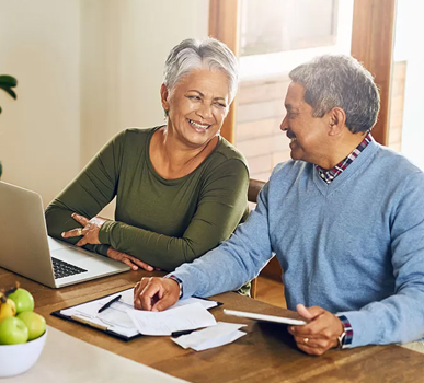 Happy couple reviewing their finances